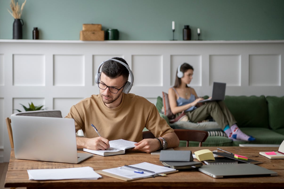 dos-amigos-que-estudian-biblioteca-usando-sus-computadoras-portatiles