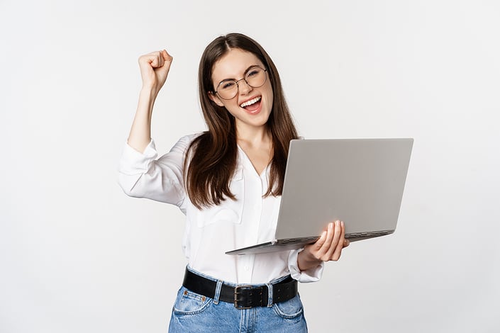 enthusiastic-office-woman-businesswoman-holding-laptop-and-shouting-with-joy-celebrating-and-rejoicing-standing-over-white-background