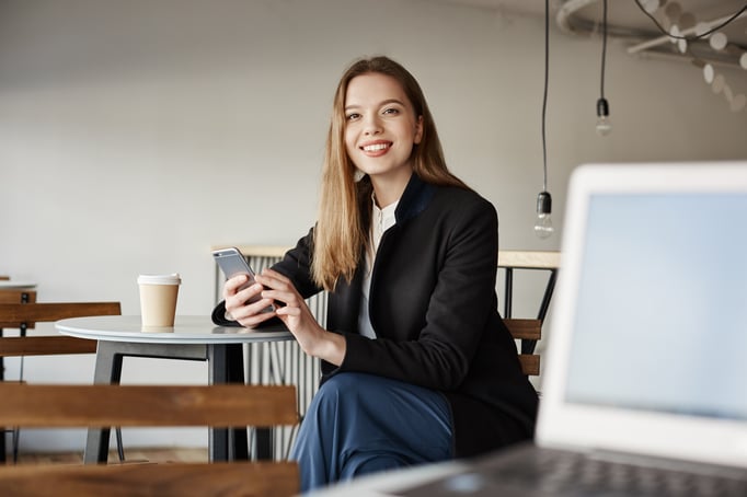gorgeous-young-female-student-sit-cafe-using-smartphone