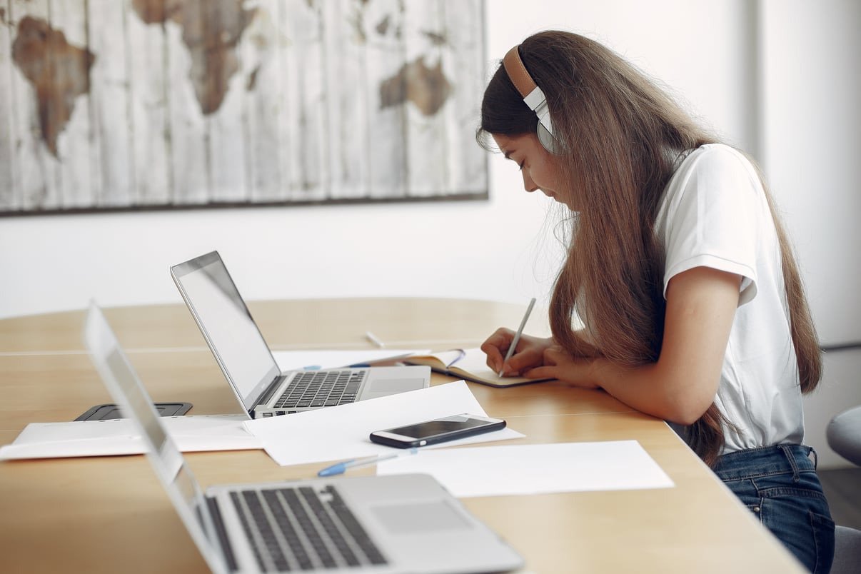 joven-estudiante-sentado-mesa-usar-computadora-portatil