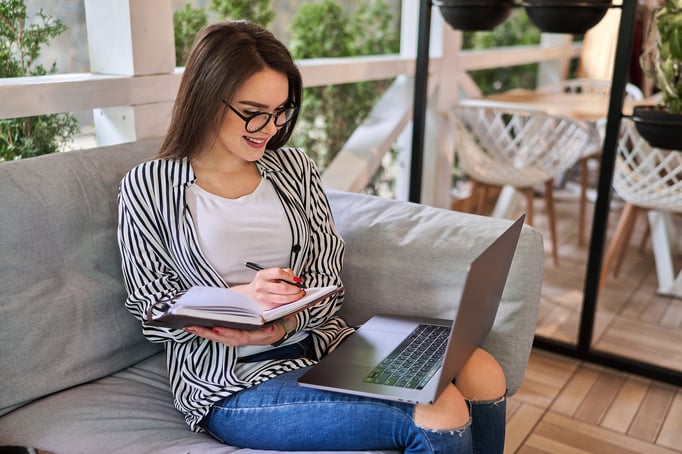 smiling-beautiful-woman-learning-home-with-laptop